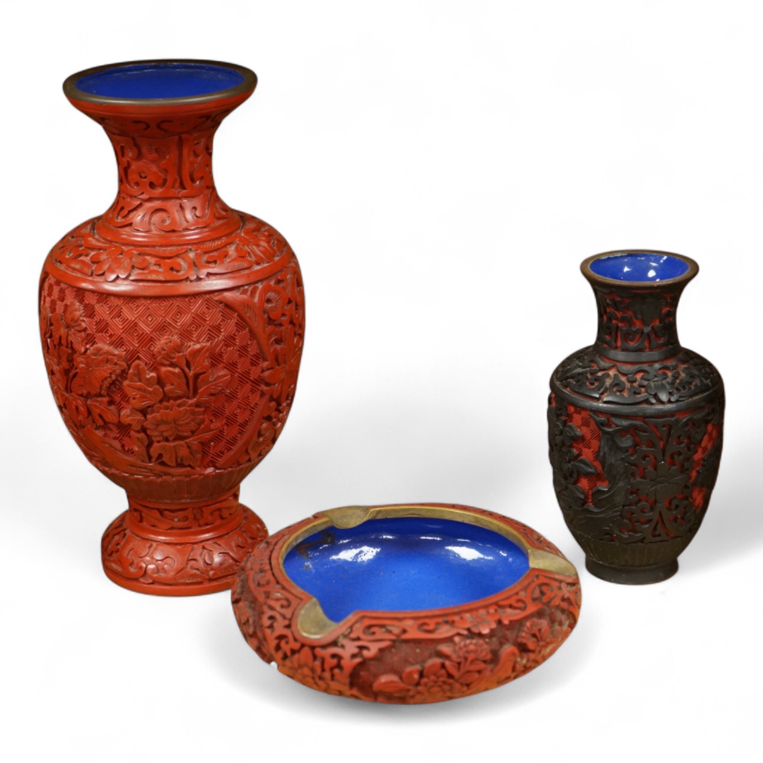 Two Chinese cinnabar lacquer vases and an ashtray, largest 20cm high